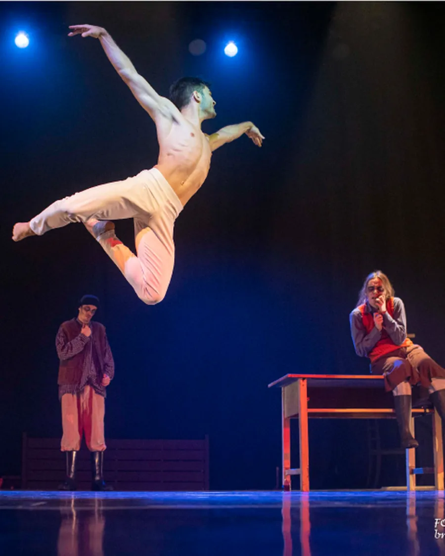 A dancer in flight above the stage